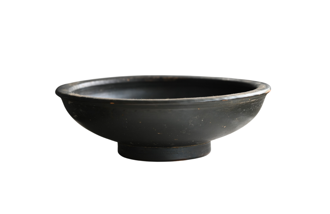 Campanian black glazed bowl from Greek Campania, 400–300 BC, with stamped palmettes and central face motif