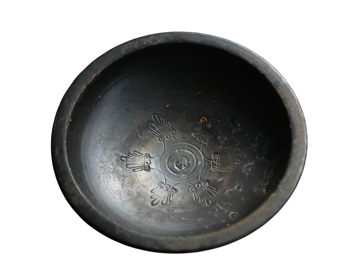 Campanian black glazed bowl from Greek Campania, 400–300 BC, with stamped palmettes and central face motif