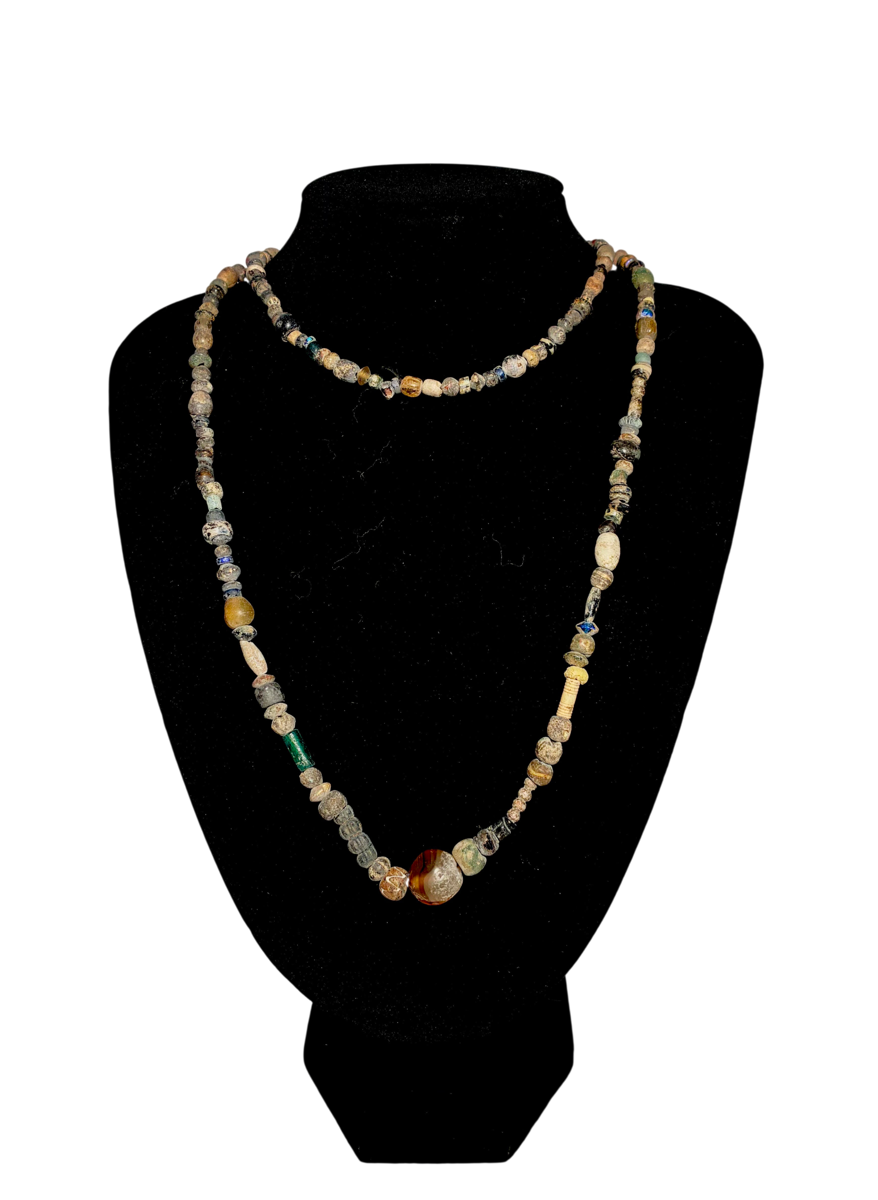 Large Roman glass bead necklace with colorful iridescent glass and engraved stone beads, c. 200 BC–300 AD